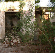 Old destroyed buildings with little safety for toddlers, face the open patio of the pubilc Xcalacoop Child Care Center in Yucatan, Mexico